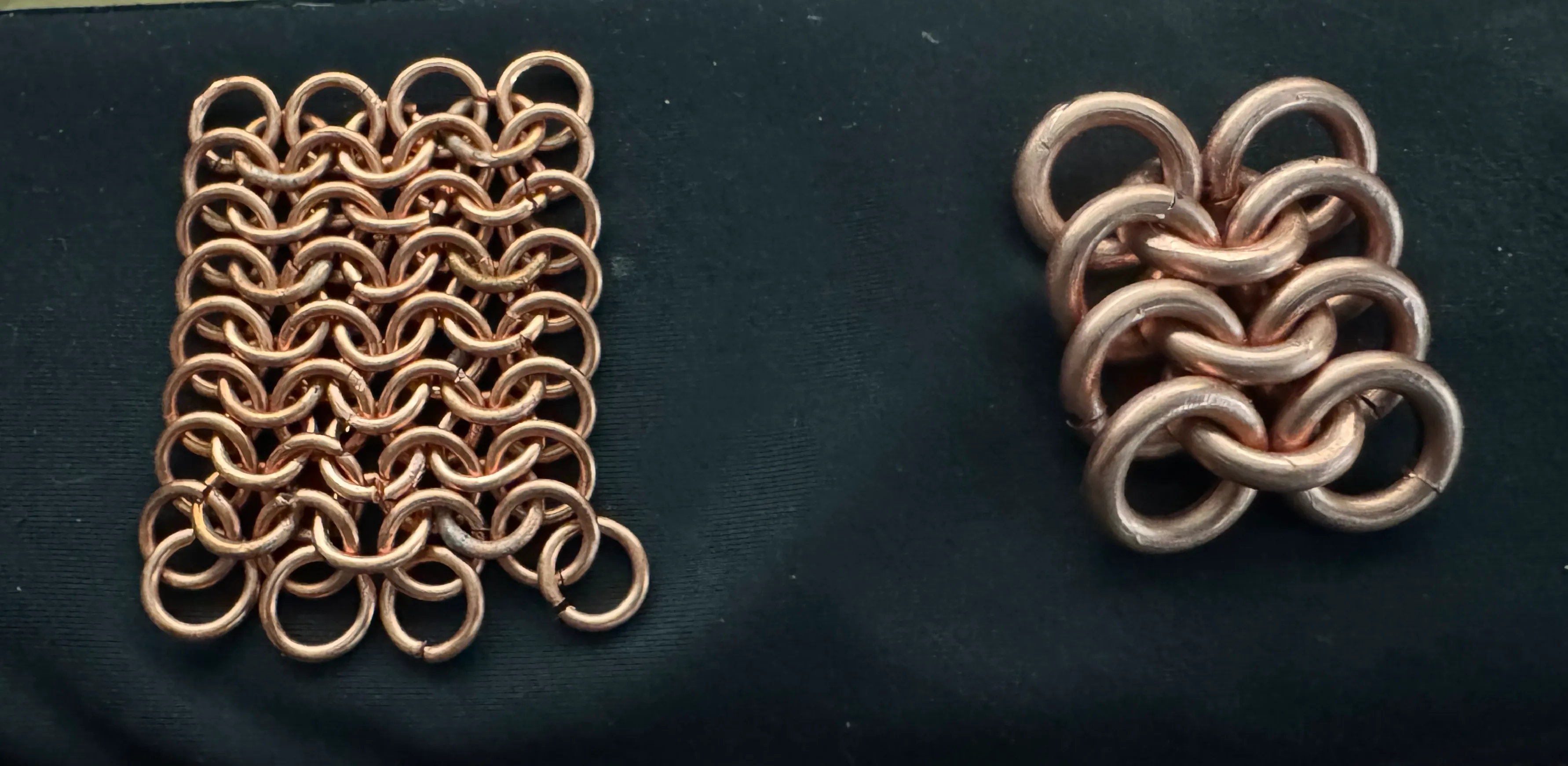 Two swatches of hand-woven chainmail on a work surface — a fine European 4-in-1 sheet on the left, a chunkier heavy-gauge piece on the right.